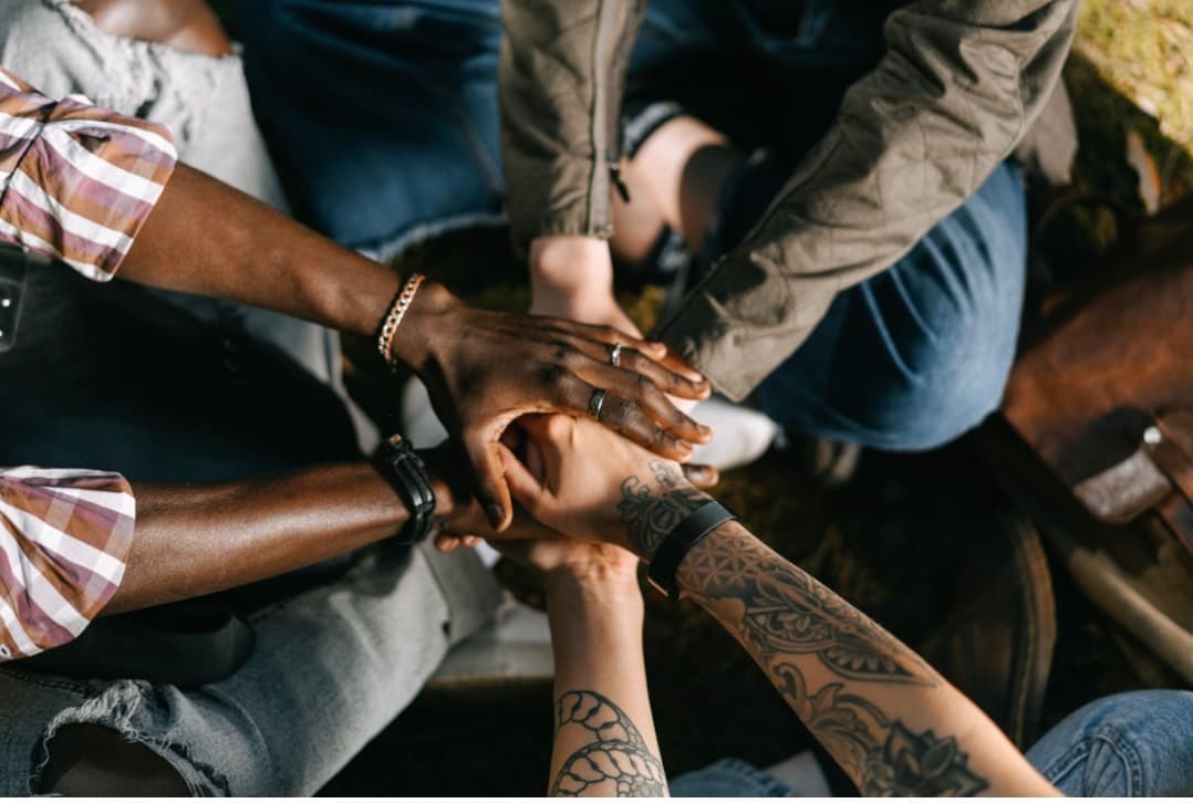 Community in reciprocal support — diverse hands coming together